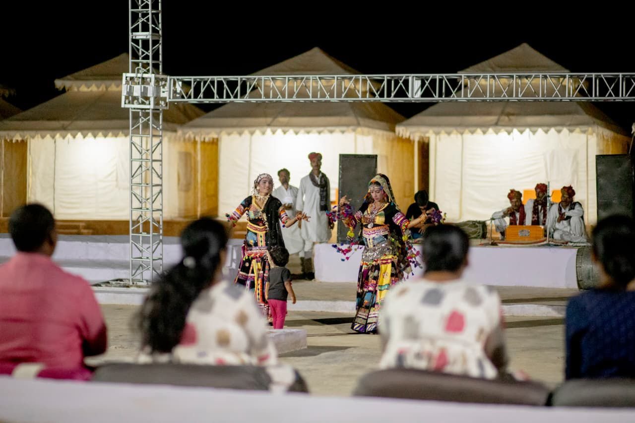Rajasthani folk dancers performing at Dusk N Dunes camp in the evening
