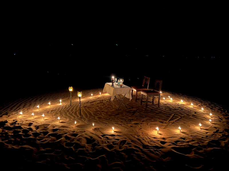 Desert dinner setup under the stars at Dusk N Dunes